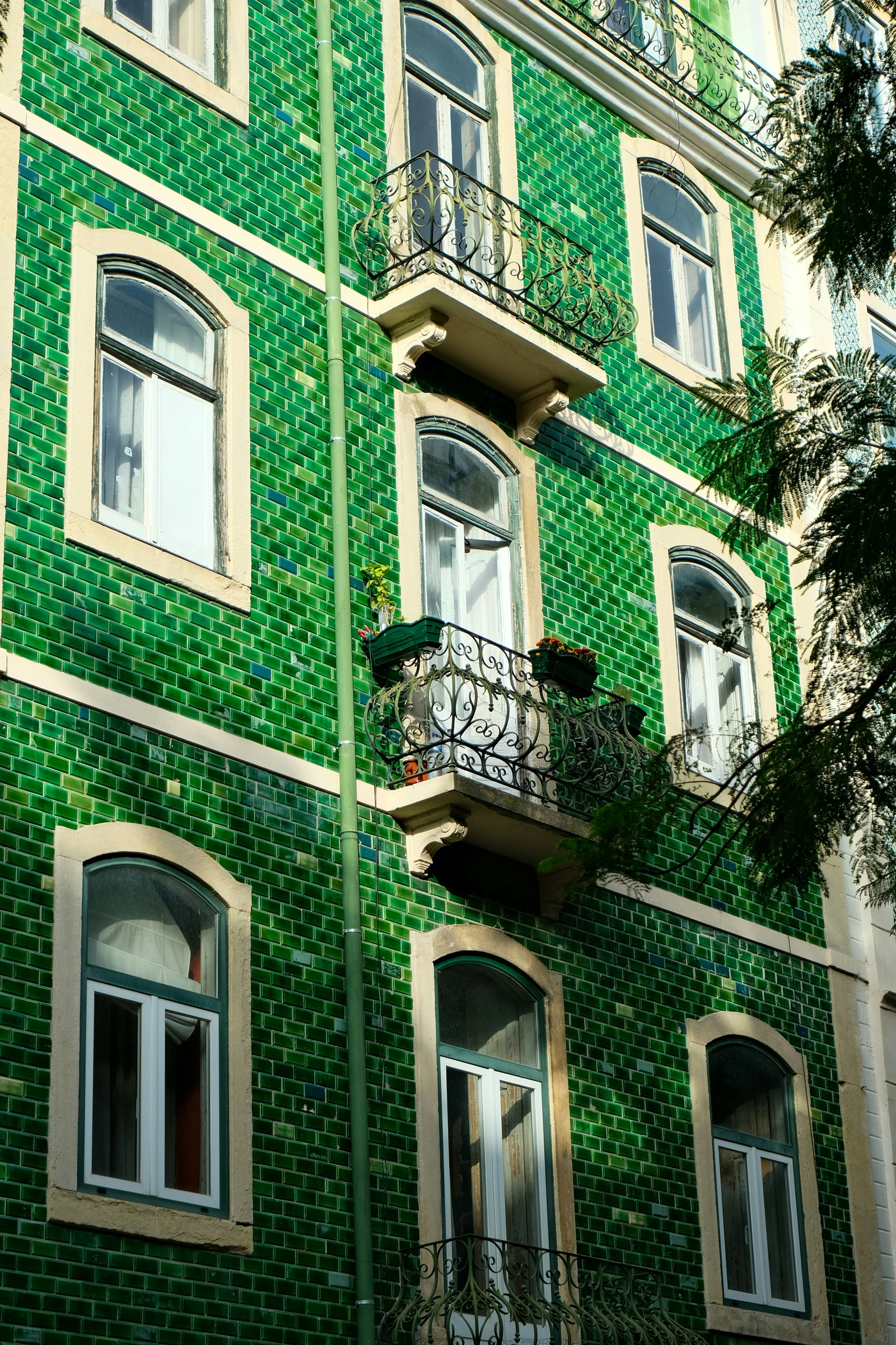 Green tiles on a fa&ccedil;ade in Lisbon.