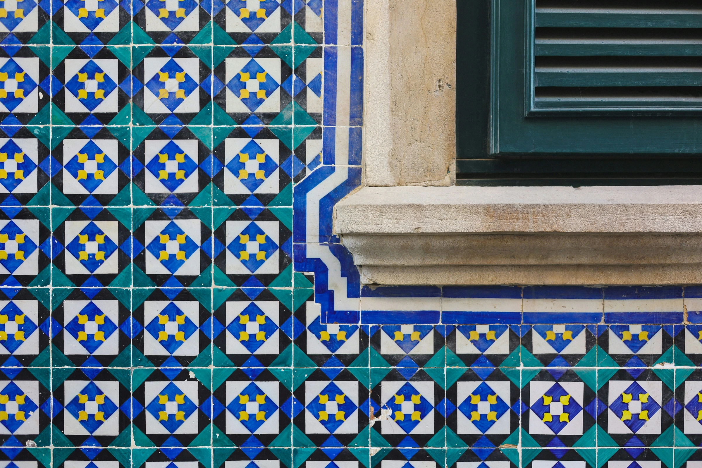 A window and blue-and-white azulejos in Lisbon.