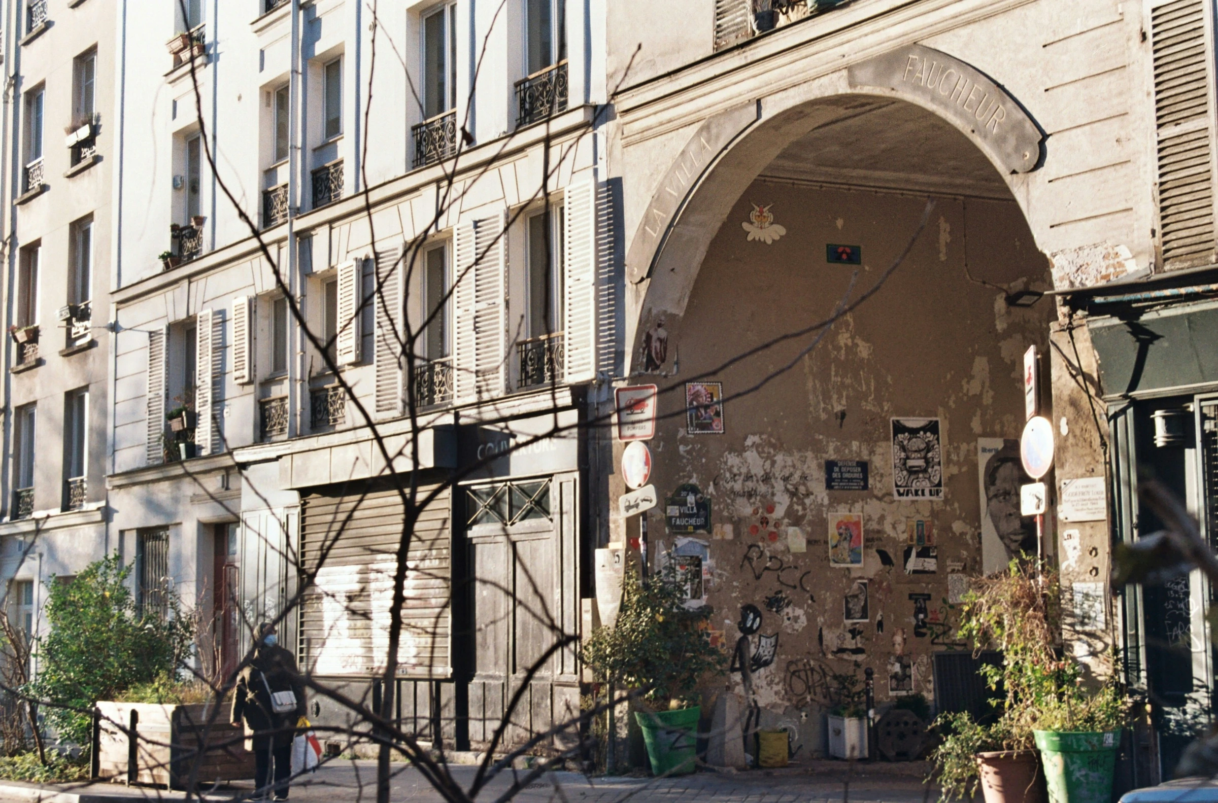 Posters and walls in a Parisian courtyard.