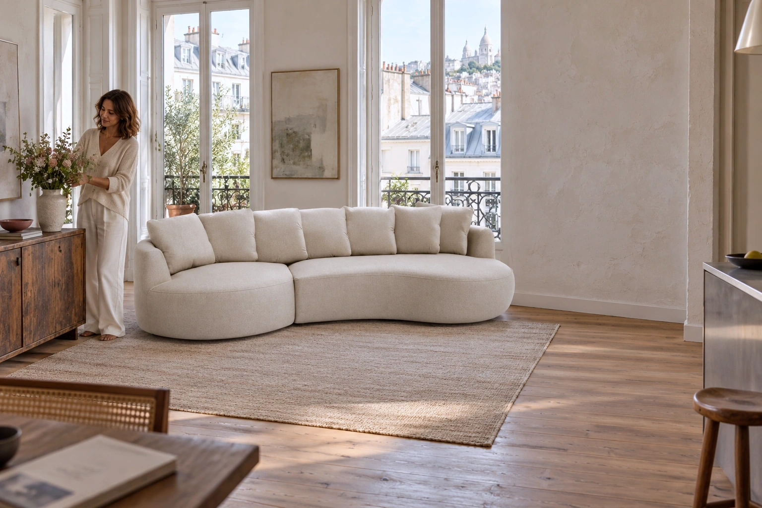 BELLEVILLE: a woman arranges flowers beside a cream sofa in a Paris apartment
