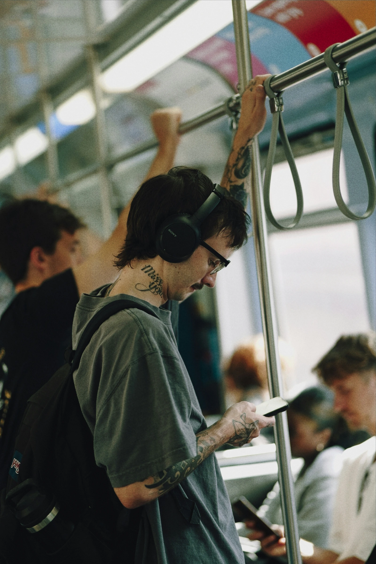 A man wearing headphones on public transport.